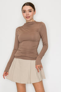 Blusa cuello alto drapeado manga larga
