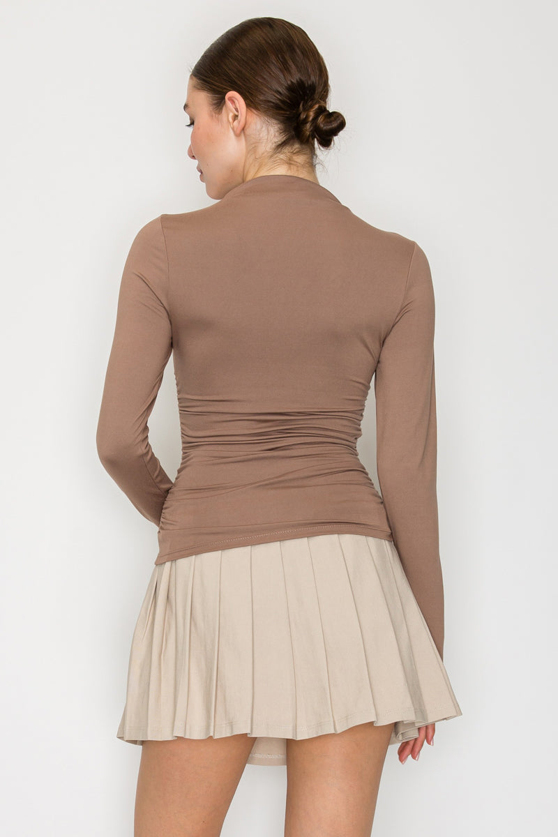 Blusa cuello alto drapeado manga larga