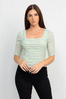 Blusa con textura y mangas de tres cuartos
