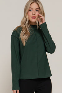 Blusa manga larga con cuello alto y costura central